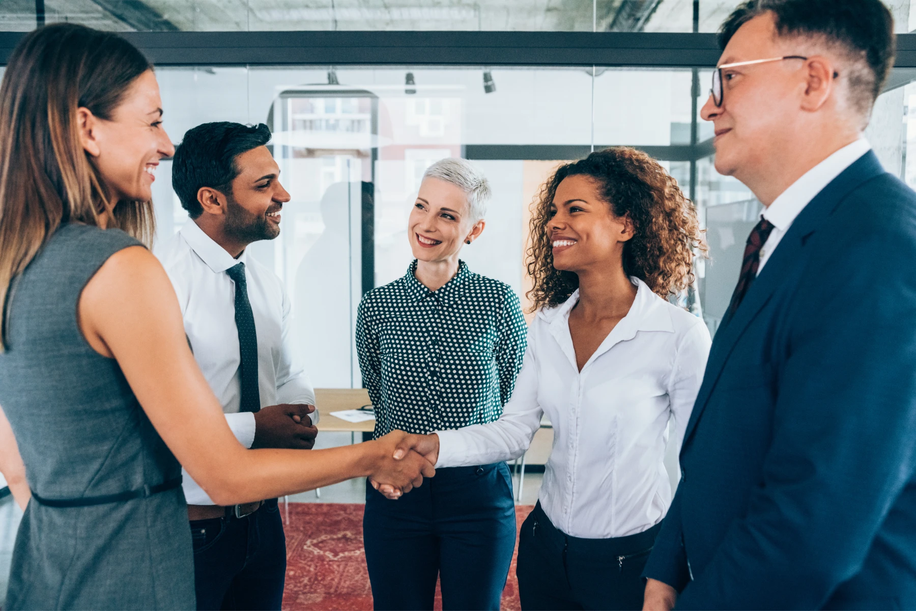 Workplace Hospitality Professionals Meeting in Corporate Office Corporate hospitality professionals shaking hands during a workplace introduction in a modern office setting